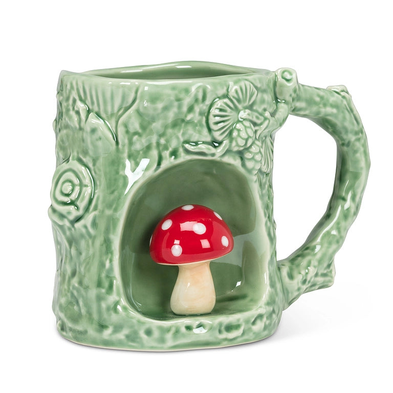 Green ceramic mug shaped like a hollow log with a 3D red and white toadstool tucked inside. 