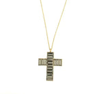Gold cross pendant set with smoky grey baguette stones on a long gold chain.